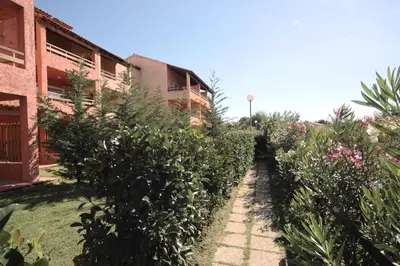 a large building with a yard in front of it at Marina Corsa Residence Apartment 3 rooms 6 persons 150 m sandy beach Ghisonaccia in Ghisonaccia