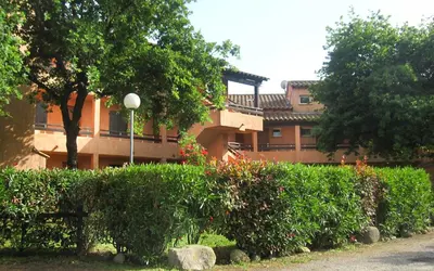 a building with a bunch of bushes and trees at Marina Corsa Residence Apartment 3 rooms 6 persons 150 m sandy beach Ghisonaccia in Ghisonaccia