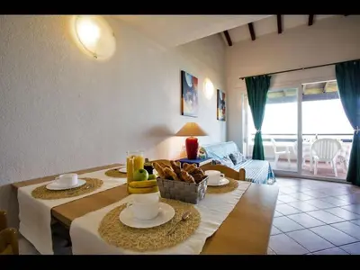 a living room with a table with food on it at Four rooms apartment Ghisonaccia - 150 m from the beach in Ghisonaccia