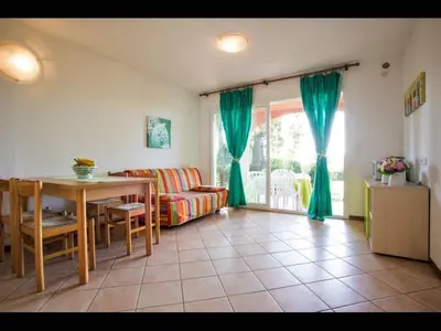 a living room with a couch and a table at Four rooms apartment Ghisonaccia - 150 m from the beach in Ghisonaccia