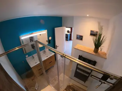 a room with a staircase with two sinks and a mirror at Le Clos des Milans in Rapale
