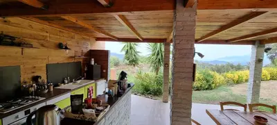 a kitchen with a counter and a table with a view at Le Clos des Milans in Rapale