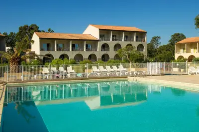 a swimming pool in front of a resort at Résidence Goélia Perla D'Isula in Linguizzetta