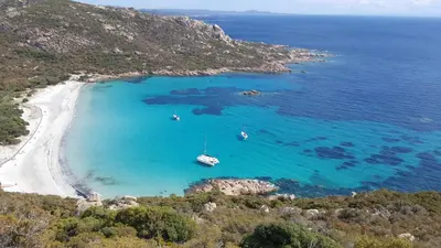 an aerial view of a beach with boats in the water at Air-conditioned apartment near Porto Vecchio, 500 m sea, 8 people, two bathrooms in Zonza