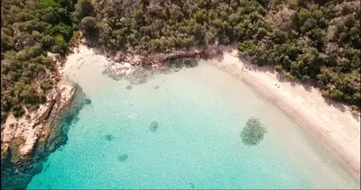 an aerial view of a beach with turquoise water at Air-conditioned apartment near Porto Vecchio, 500 m sea, 8 people, two bathrooms in Zonza