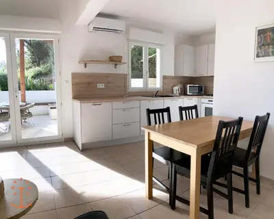 a kitchen and dining room with a table and chairs at Ogliastrello in Olmeto