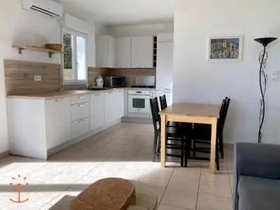 a kitchen and dining room with a table and chairs at Ogliastrello in Olmeto