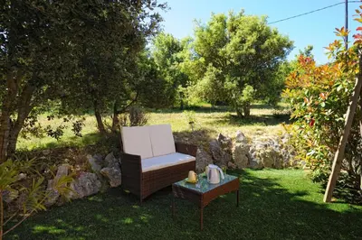 a chair and a table in a yard at Résidence Canava in Bonifacio