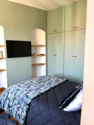 a bedroom with a bed and a flat screen tv at Chez Andrea, Centre Historique Ajaccio in Ajaccio