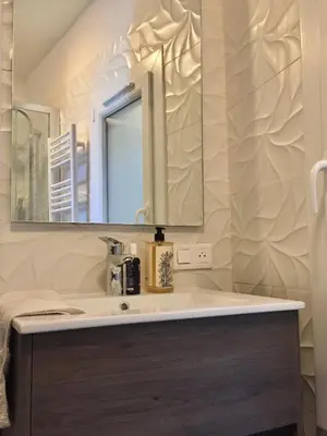 a bathroom with a sink and a mirror at Chez Andrea, Centre Historique Ajaccio in Ajaccio