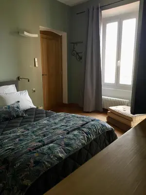 a bedroom with a bed and a window at Chez Andrea, Centre Historique Ajaccio in Ajaccio