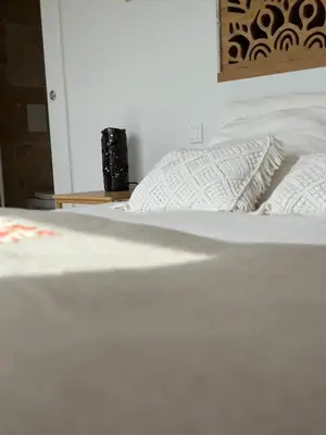 a bed with white sheets and a pillow on it at A Casa Vadiiolina - Chambres d'hôtes d'exception in Sollacaro