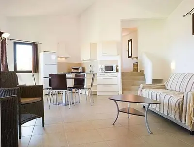 a living room with a couch and a table at Résidence A Rundinella in Porto-Vecchio