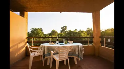 a table on a balcony with a table and chairs at Studio 2 people - 150 m from de sea - Ghisonaccia in Ghisonaccia