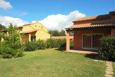a building with a bunch of bushes and trees at Studio 2 people - 150 m from de sea - Ghisonaccia in Ghisonaccia