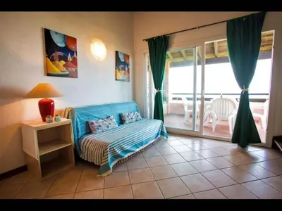 a kitchen and dining room with a table and chairs at Marina Corsa Res 4 rooms apartment 2 bathrooms 150 m from the sea Ghisonaccia in Ghisonaccia