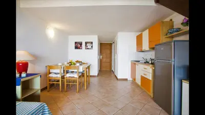 a kitchen with a table with a blue table cloth on it at Marina Corsa Residence 3rooms apartment 150 m from the beach - Ghisonaccia in Ghisonaccia