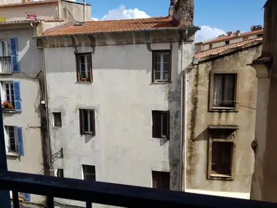 a white building with windows and a roof at AJACCIO / CENTRE VILLE / PORT 2mn / PARKING PROCHE/ TOUTES COMMODITES in Ajaccio