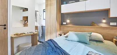 a bedroom with a bed and a desk in it at Camping Porto Vecchio in Porto-Vecchio