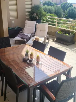 a wooden table and chairs on a patio at Christelle in Propriano