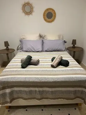 a bed with pillows on it in a bedroom at Tradition Corse & Modernité Ì Caseddi dì Barabè Appartement A Cantina in Granace