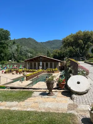a garden with a pavilion with flowers and plants at Tradition Corse & Modernité Ì Caseddi dì Barabè Appartement A Cantina in Granace