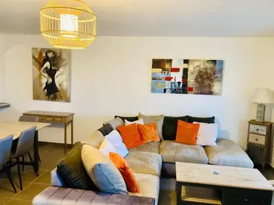 a living room with a couch and a table at Appartement Cemiliana in Bonifacio