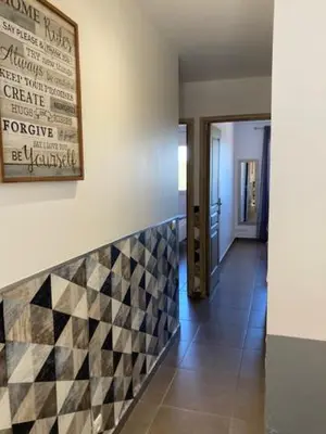a hallway with a checkered tile on a wall at Appartement Cemiliana in Bonifacio