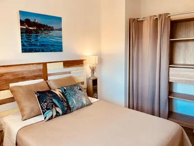 a bedroom with a bed and a window at Appartement Cemiliana in Bonifacio