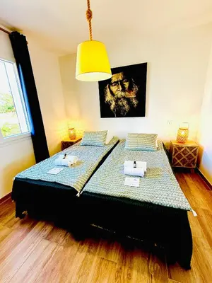 a bedroom with a bed in a room with a lamp at Casamarina2a Maisons bord de mer in Ghisonaccia