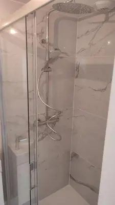 a shower with a glass door in a bathroom at Le Luciani in Coti-Chiavari