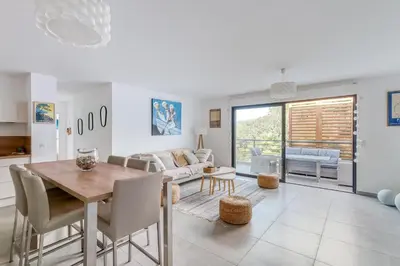 a kitchen and living room with a table and chairs at Le Luciani in Coti-Chiavari