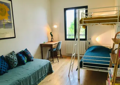 a bedroom with a bunk bed and a desk at Villa Poggio in Santa-Maria-Poggio