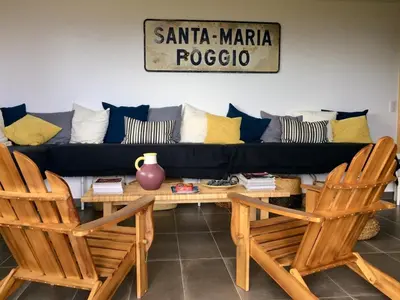 a living room with a couch and two chairs at Villa Poggio in Santa-Maria-Poggio