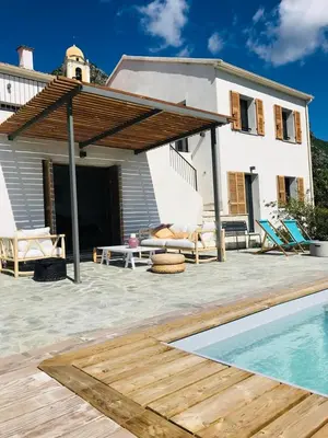 a house with a patio and a swimming pool at Villa Poggio in Santa-Maria-Poggio