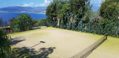 an overhead view of a tennis court next to the water at Domain U Tempu Persu Sleeps 12 with Park in Porticcio