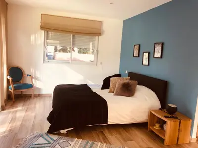 a bedroom with a bed and a blue wall at A MUREDDA in Bonifacio