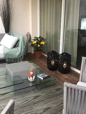 a living room with a glass coffee table and candles at A MUREDDA in Bonifacio