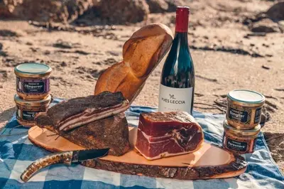 a plate of bread and a bottle of wine at A MUREDDA in Bonifacio