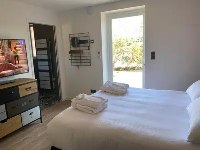 a bedroom with a bed with two towels on it at Villa Ghjuvan - Sea, Mountain & Spa in Peri