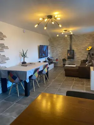 a dining room with a table and a couch at Villa Ghjuvan - Sea, Mountain & Spa in Peri