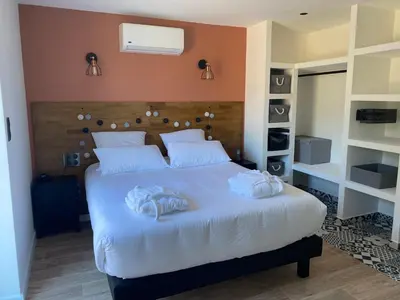 a bedroom with a bed with two towels on it at Villa Ghjuvan - Sea, Mountain & Spa in Peri