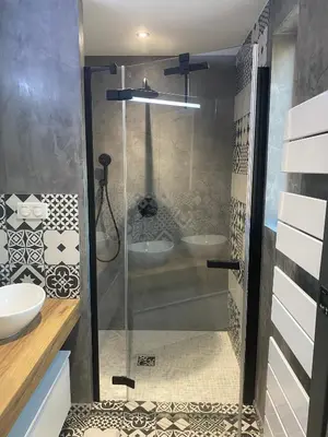 a shower with a glass door in a bathroom at Villa Ghjuvan - Sea, Mountain & Spa in Peri