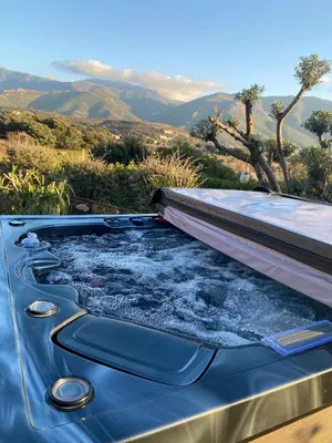 a hot tub with snow on top of a roof at Villa Ghjuvan - Sea, Mountain & Spa in Peri