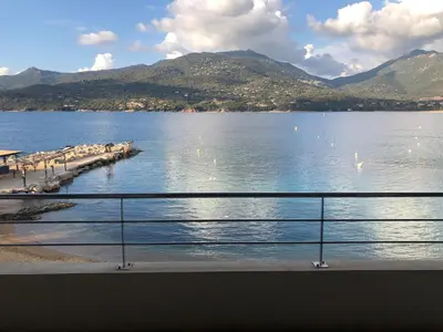 a view of a body of water with mountains at Appartement les pieds dans l'eau 3 Chambres - Propriano - Corse in Propriano