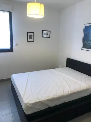 a white bedroom with a bed in a room at Appartement les pieds dans l'eau 3 Chambres - Propriano - Corse in Propriano
