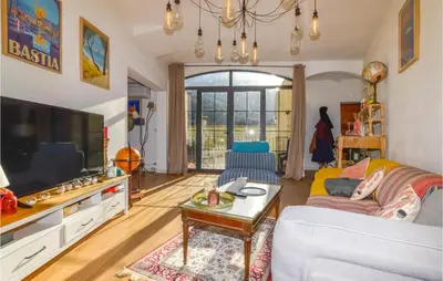 a living room with a couch and a tv at Lovely Home In Montegrosso With Wifi in Montegrosso