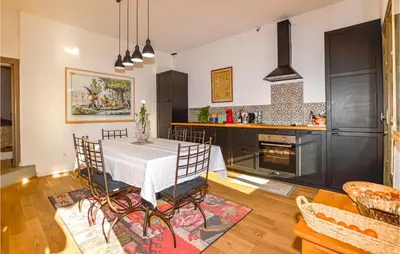 a kitchen with a table and chairs in a room at Lovely Home In Montegrosso With Wifi in Montegrosso