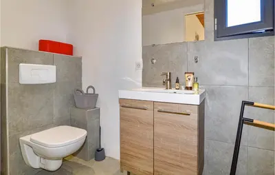 a bathroom with a toilet and a sink at Lovely Home In Montegrosso With Wifi in Montegrosso
