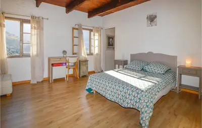 a bedroom with a bed and a desk and windows at Lovely Home In Montegrosso With Wifi in Montegrosso